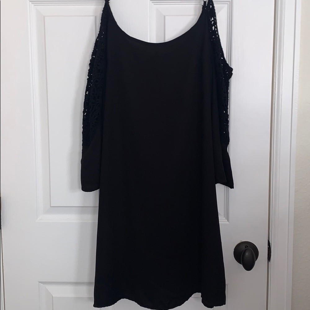 Open shoulder black dress.